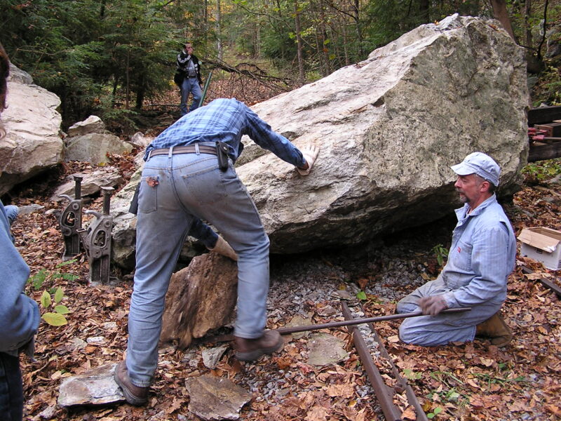 workers removing boulder blocking railway