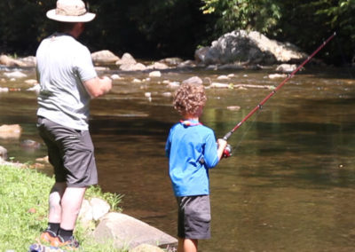 dad & son fishing in river