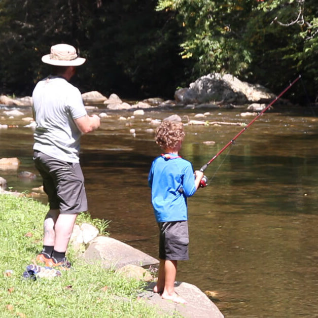 Fishing father- son fishing in river
