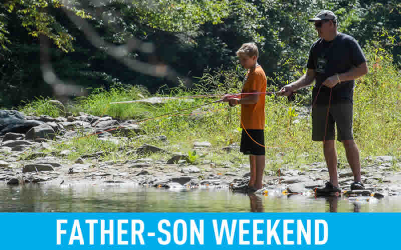 dad and son fishing at riverbank link to father-son weekend