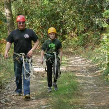 father-son with activity gear on trail