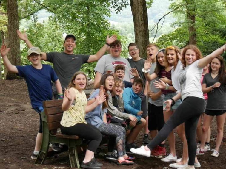 kids and staff waving