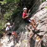 two girls rappelling
