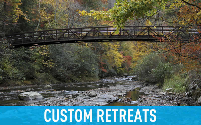footbridge over river in fall link to retreats