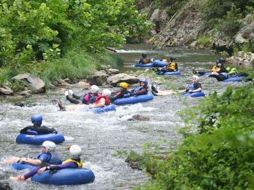 group tubing in river rapids