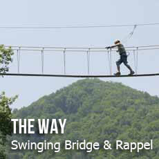 person on swinging bridge
