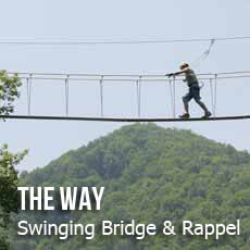 The Way person on swinging bridge