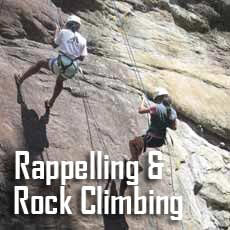 two kids rappelling rock face