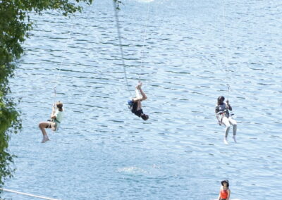 three kids on water landing zipline seen from above
