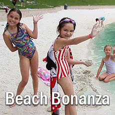 girls on beach waving