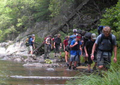 group backpacking along mountain stream