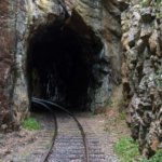 railroad tracks in mountain tunnel