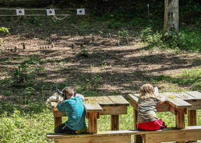 2 kids shooting on target range