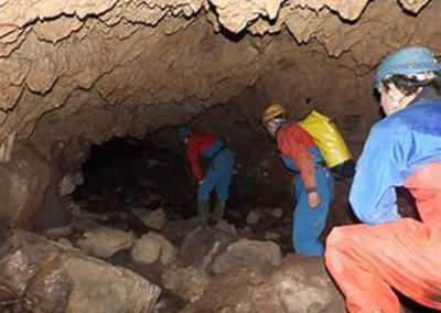 3 people entering cave